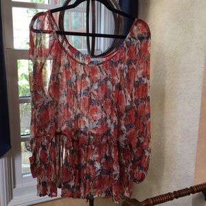 Tunic in bright orange flowers, longsleeved, gathered hem.